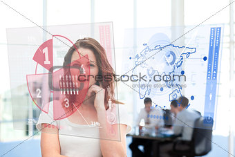 Smiling businesswoman looking at red pie chart interface