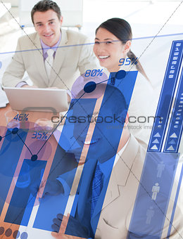 Overview of cheerful colleagues looking at blue chart futuristic interface