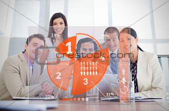 Smiling business workers looking at orange pie chart interface