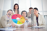 Smiling business workers looking at colorful pie chart interface
