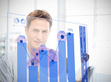 Businessman looking at blue chart interface