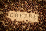 Coffee beans surrounding coffee stamp on sack