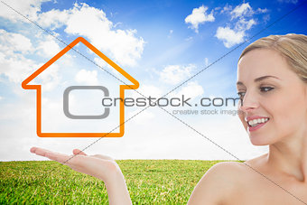 Smiling woman looking at house outline