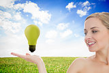 Blonde woman presenting green bulb