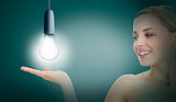 Woman presenting light bulb