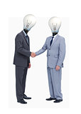Businessman with light bulb heads greeting with a handshake