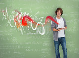Smiling boy posing in front of chalk board