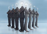 Businessman and businesswoman with light bulb heads multiplied