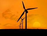 Wind turbines with a sunset in line