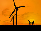Wind turbines and family with a sunset