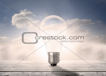 Light bulb standing floorboards in the sky