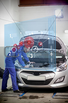 Mechanic with open hood with futuristic interface