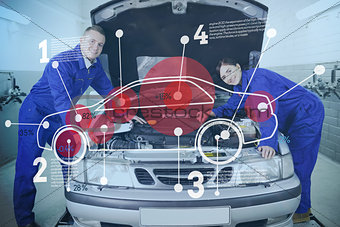 Two happy mechanics consulting futuristic interface with open hood