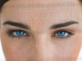Attractive blue eyed woman with binary coding on face