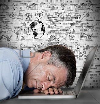 Businessman sleeping on his laptop with drawings and charts