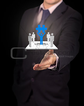 Businessman presenting human forms on jigsaw pieces