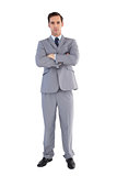 Serious businessman standing with his arms crossed