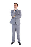 Serious businessman standing and thinking