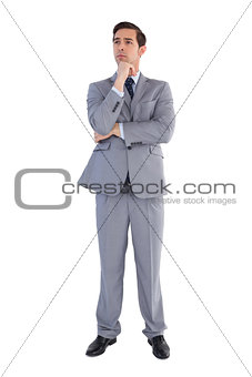 Serious businessman standing and thinking