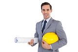 Smiling architect holding plans and hard hat