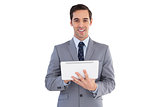 Smiling businessman holding a tablet computer