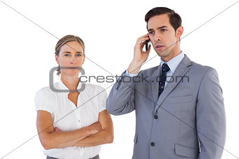 Businessman on the phone next to his colleague