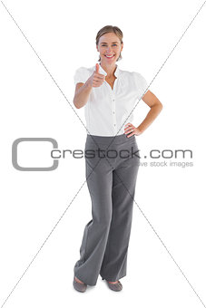 Smiling businesswoman showing her thumb up