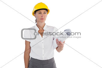 Serious female architect holding plans and hard hat
