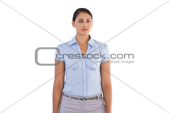 Serious businesswoman standing alone