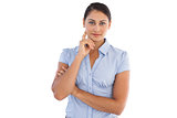 Businesswoman standing alone with her hand to her face