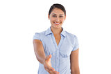 Smiling businesswoman outstretching her hand