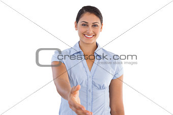 Smiling businesswoman outstretching her hand