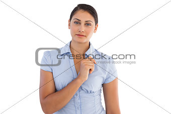 Serious businesswoman holding a pen