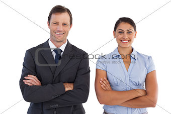 Smiling co workers standing next to each other