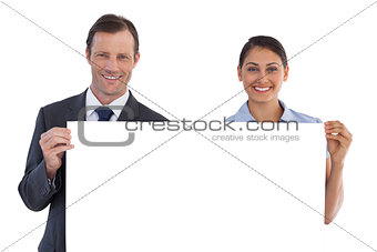 Smiling co workers holding a blank copy space