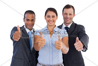 Group of smiling business people showing their thumbs up
