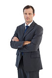 Charismatic businessman standing with arms crossed