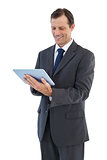 Smiling businessman holding a tablet pc