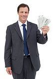 Smiling businessman holding dollar bills