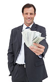 Smiling businessman holding cash
