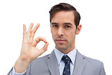 Serious businessman showing ok sign