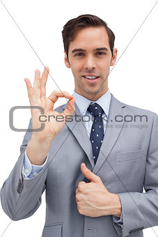 Smiling businessman showing ok sign