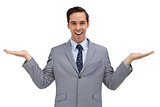 Smiling businessman presenting something with his hands