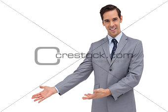 Smiling businessman giving a presentation with his hands