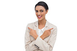 Cheerful businesswoman with her arms crossed and fingers pointing