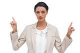 Serious businesswoman with hands up