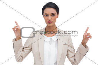 Serious businesswoman with hands up