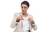 Businesswoman pointing at the camera