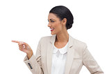 Profile view of a smiling businesswoman pointing