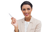 Confident businesswoman holding a pen